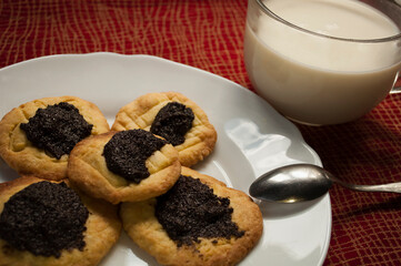 cookies with poppy seed filling and milk. Photo on a sunny day, daylight natural sunlight