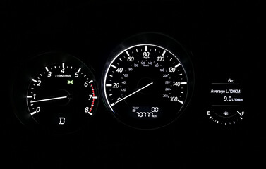 Car speedometer on black background
