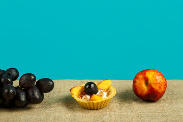 dessert with fruit with whipped cream and fruits on a blue background.