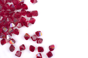 Precious stones of red color are scattered on a white background isolated