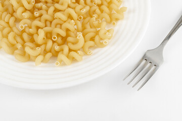 Prefabricated pasta on a plate with a fork white background