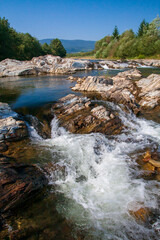 Fototapeta na wymiar Mountain River in the Carpathians, stones and splashing in the foreground