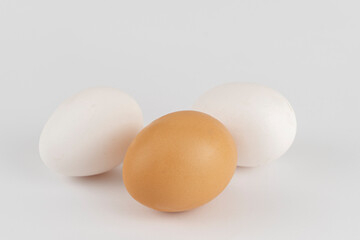 White and brown chicken eggs on a background close-up