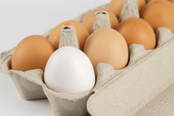 Chicken eggs in a cardboard tray close-up white and brown