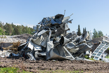 Pile of scrap metal from a dismantled building at a demolition site. Industrial background.