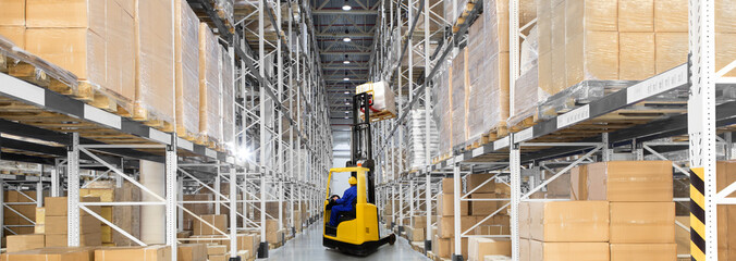 A large distribution warehouse with yellow forklift © hacohob