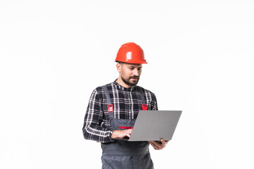 Repairman in hemlet using laptop against white background