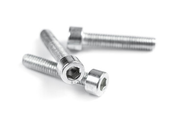 three screw nuts on a white background, close up. Stainless screws, bolts for construction and repair