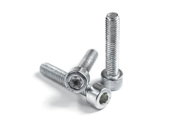 three screw nuts on a white background, close up. Stainless screws, bolts for construction