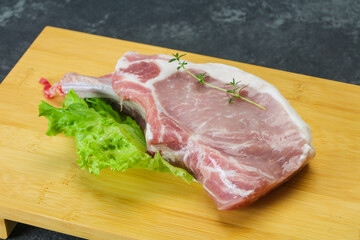 Raw pork bone steak over wooden