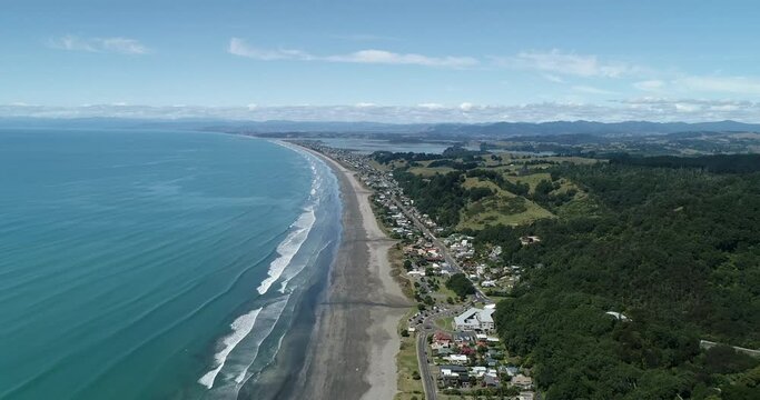 4k aerial forward tracking motion above the popular tourist beach of Ohope Beach, known as one of the top beaches on the North Island of New zealand