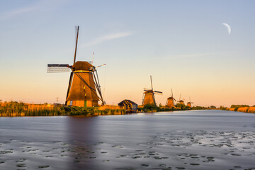 Naklejka premium The windmills near the water in Kinderdijk, a UNESCO World Heritage site in Rotterdam, Netherlands