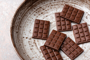 Mini chocolate bars on a plate.