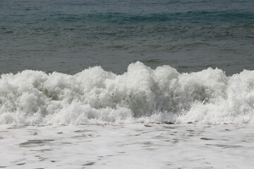 Splash of sea water after hitting a rocky cliff in southwestern Cyprus near the town of Paphos. Stormy and dangerous situation. Huge masses of water. Avalanche sea. Flood is coming