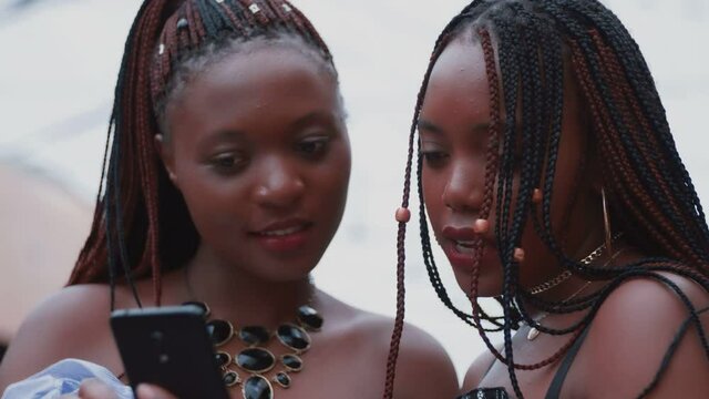Beautiful African girls are using a phone