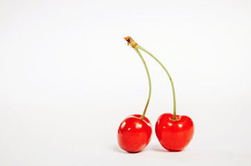 two cherries on a white