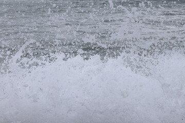 Splash of sea water after hitting a rocky cliff in southwestern Cyprus near the town of Paphos. Stormy and dangerous situation. Huge masses of water.