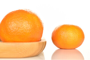 Bright yellow juicy, fresh, organic tangerines, close-up, on a white background.
