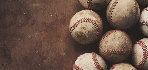 Group of old used baseball balls for sport, copy space on grunge brown background for vintage style. - 355275804