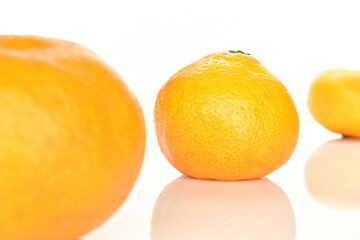 Bright yellow juicy, fresh, organic tangerines, close-up, on a white background.