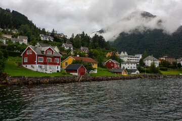 Fototapeta na wymiar Beautiful houses on the shore of the fjord in Balestrand. Norway
