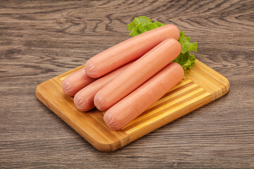 Tasty meat sausages over board