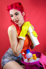 Girl on a pink background in yellow gloves