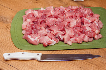 Sliced raw meat background. Cooking pork meat. Sliced meat on a cutting board. Ingredient for cooking