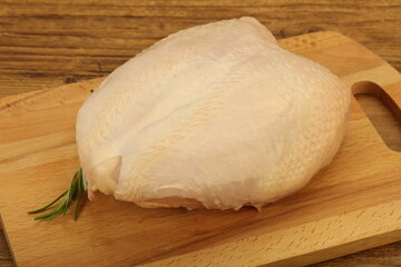Raw whole chicken breast with skin