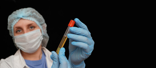 Female doctor in medical protective mask and gloves holding a 
test tube with the covid-19 vaccine.  Healthcare And Medical concept.