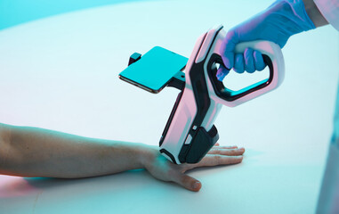 Doctor's hand makes an injection chip, a modern syringe with scanner, into hand of a man, chipization of the population.