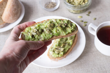 Sandwiches with avocado and pumpkin seeds