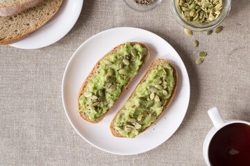 Sandwiches with avocado and pumpkin seeds