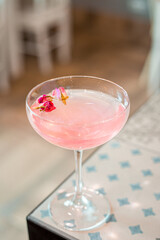 Pink Rose Sparkle Cocktail in the Bar, Blurred Background