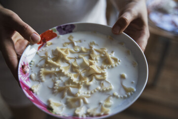 Delicious pasta with milk on a plate