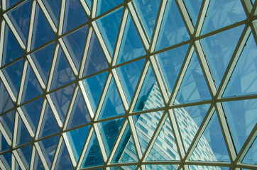 Glass windows grid on blue sky and building