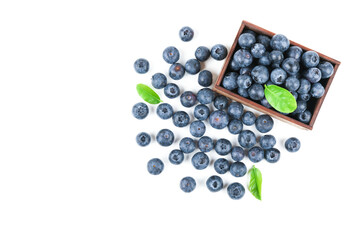 blueberry berries are in the wood box isolated on white background