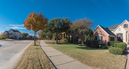 Panoramic view colorful sidewalk pathway in residential area suburban Dallas, Texas, USA in fall season