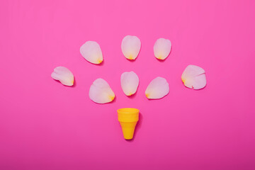 Summer minimal concept. Ice cream cone with rose leaves on punchy pastel background. Flat lay. Top view. Creative layout.