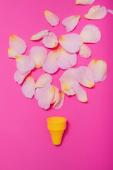 Summer minimal concept. Ice cream cone with rose leaves on punchy pastel background. Flat lay. Top view. Creative layout.