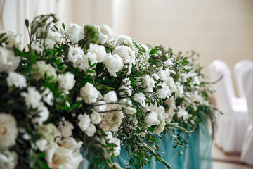 Obraz na płótnie Canvas Decorative photo zone of flowers for the banquet. Scenery of flowers.