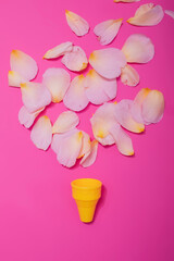 Summer minimal concept. Ice cream cone with rose leaves on punchy pastel background. Flat lay. Top view. Creative layout.