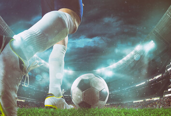Close up perspective of a soccer scene at night match with player kicking the ball