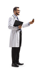 Male doctor holding a bottle of pills