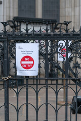 Sign outside Royal Courts of Justice in London, Strand, England advising of social distancing requirements following Coronavirus COVID-19 pandemic- 4