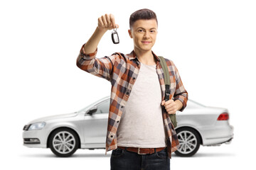 Male teenager holding a car key from his new silver car