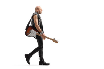 Punk rock musician with a guitar walking