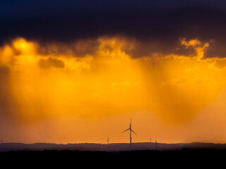 golden sunsten with a view of wind turbines