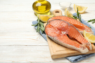 Composition with salmon meat and spices on wooden background, space for text