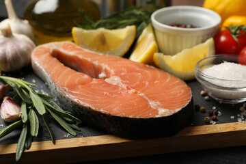 Composition with salmon meat and spices on wooden background, close up